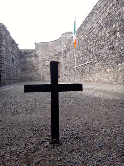 The cross in the center of the photo represents the 13 men who were executed in that spot. The other cross, in the background, represents were Connolly was shot. In the middle of the crosses is an Irish flag representing the Irish identity.
